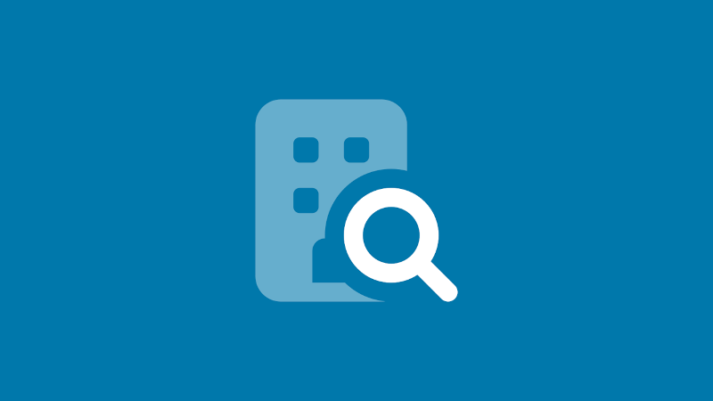 Building with magnifying glass icon