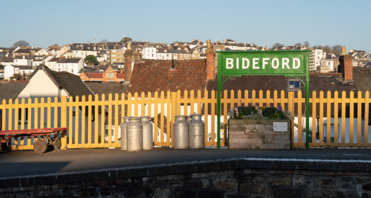 Green sign containing the text 'Bideford' on the platform of the former Bideford Railway station, located in Bideford East (East-the-Water) ward.
