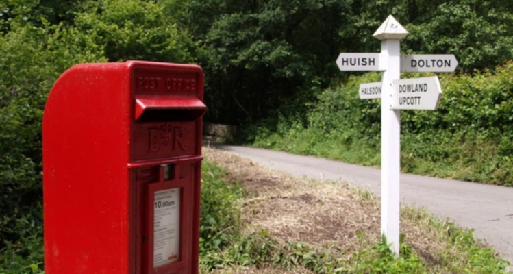 Postbox and road sign in Two Rivers and Three Moors ward