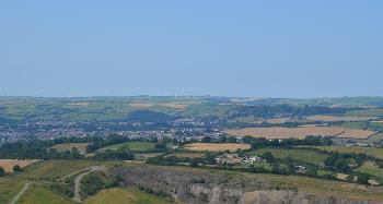 DCA 14: Far-reaching views north-east from Codden Hill across Venn Quarry towards Barnstaple, with Fullabrook Down Wind Farm visible on the skyline.