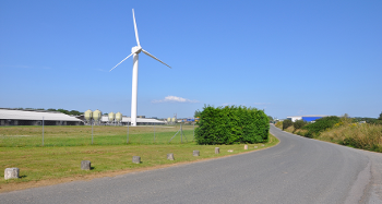 DCA 32: A wind turbine, chicken sheds and warehouses at Winkleigh Airfield introducing an industrial character to the otherwise rural landscape.