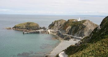 DCA 38: The quay and access road at the south of the island, with Lundy South Lighthouse perched in a prominent position on an outcrop extending from the main island.