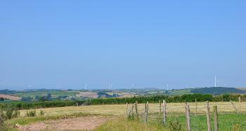DCA 44: View across undulating land towards wind turbines at Fullabrook Down