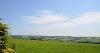 DCA 53: View east from the outskirts of Bishop's Nympton across pastoral farmlands to Batsworthy Cross wind farm, the turbines forming prominent moving features on the skyline. 