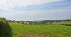 DCA 64: Pastoral farmland sloping towards the wooded valley of the River Carey, with distant views of Bodmin Moor. 