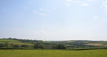 DCA 64: Three wind turbines east of Tetcott visible in the skyline, partially interrupting the distant view of Dartmoor. 