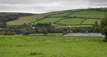 Figure 2.23: Fields with solar panels in the background under hills.