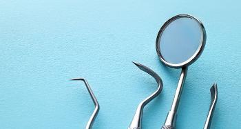 Picture of various dental tools on a light blue background. 