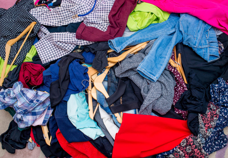 Pile of multicoloured clothes on the ground