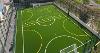 Image of a new football pitch with two goals at either end and a bright green floor with white and yellow line markings 