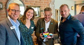 Photo of Fiona Henderson and 3 men smiling for a photo