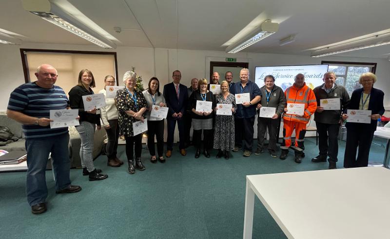 Photo of the staff and their certificates at the Long Service Awards Ceremony 