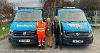 Councillor Chris Leather and two members of the Waste and Recycling team stood in between the two vans, with Binderella on the left and Lightening McClean on the right