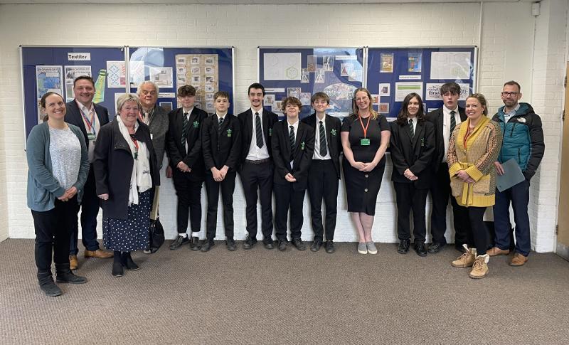 Various students, staff, Torridge Councillors and Officers smiling for a photo at Great Torrington School