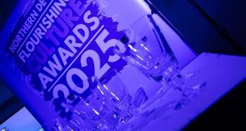 Photo of glasses in front of a Flourishing Culture Awards poster