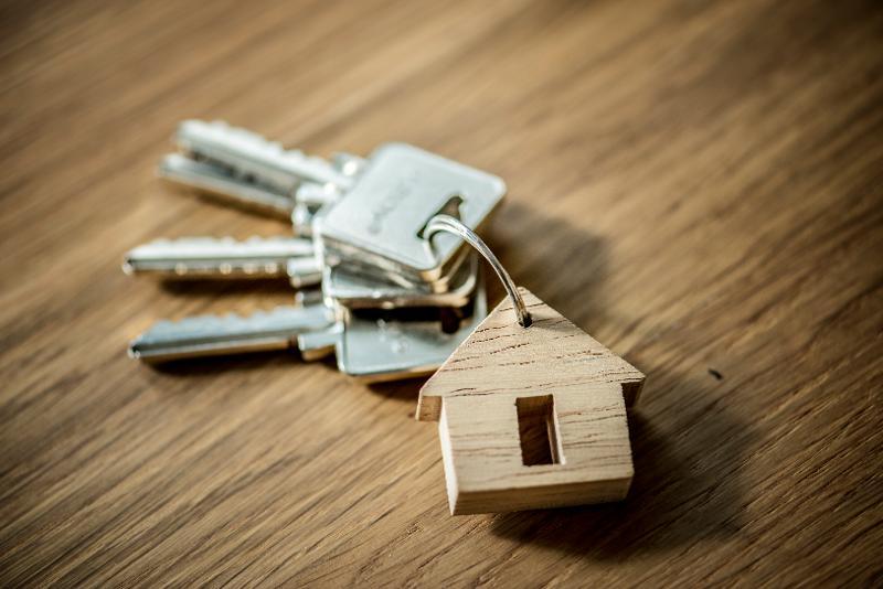 Picture of house keys with a wooden house keyring