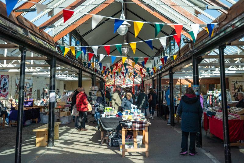 Picture of the newly refurbished Torrington Pannier Market with bunting running across the ceiling