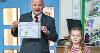 Councillor Bushby with the third place winner from West Croft School as she receives her prize. 