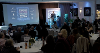 A photo of the presentation evening at the Flourshing Culture Awards, with many people sat around tables and someone presenting at the front.