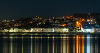 A photo of Appledore at night with the lights reflecting on the water
